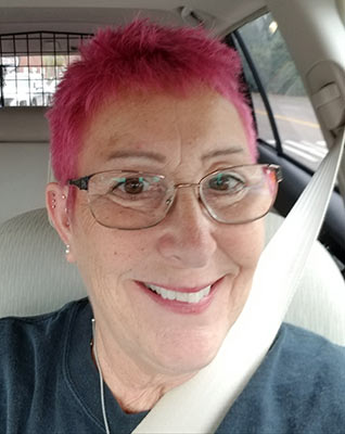 Emily Cravedi dyes her hair pink for Breast Cancer Awareness Month.