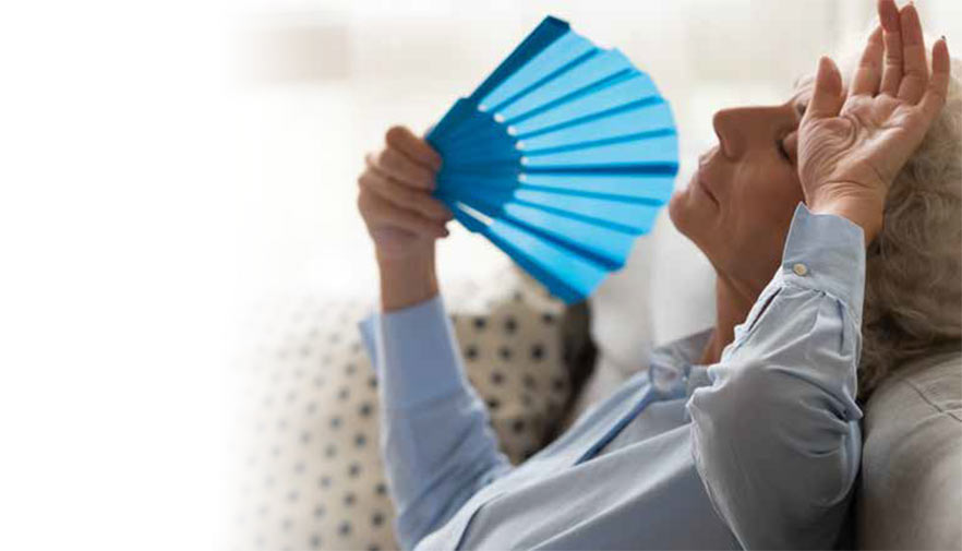 A woman with hot flashes cooling off