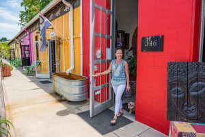 AA woman at Asheville's River Arts District walks out of Sunnyside Trading Co. Photo by ExploreAsheville.com